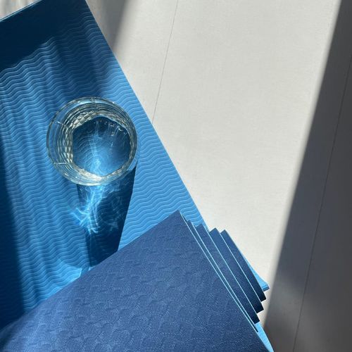 Sunlight hitting a yoga mat in a clean modern room.